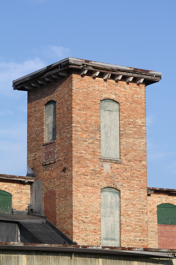 Old brick building with boarded windows